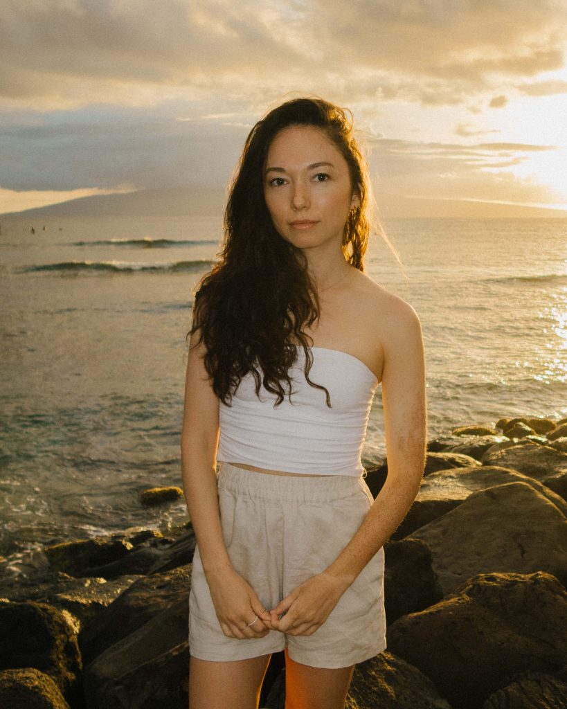 Girl standing on the beach in Maui Hawaii during sunset